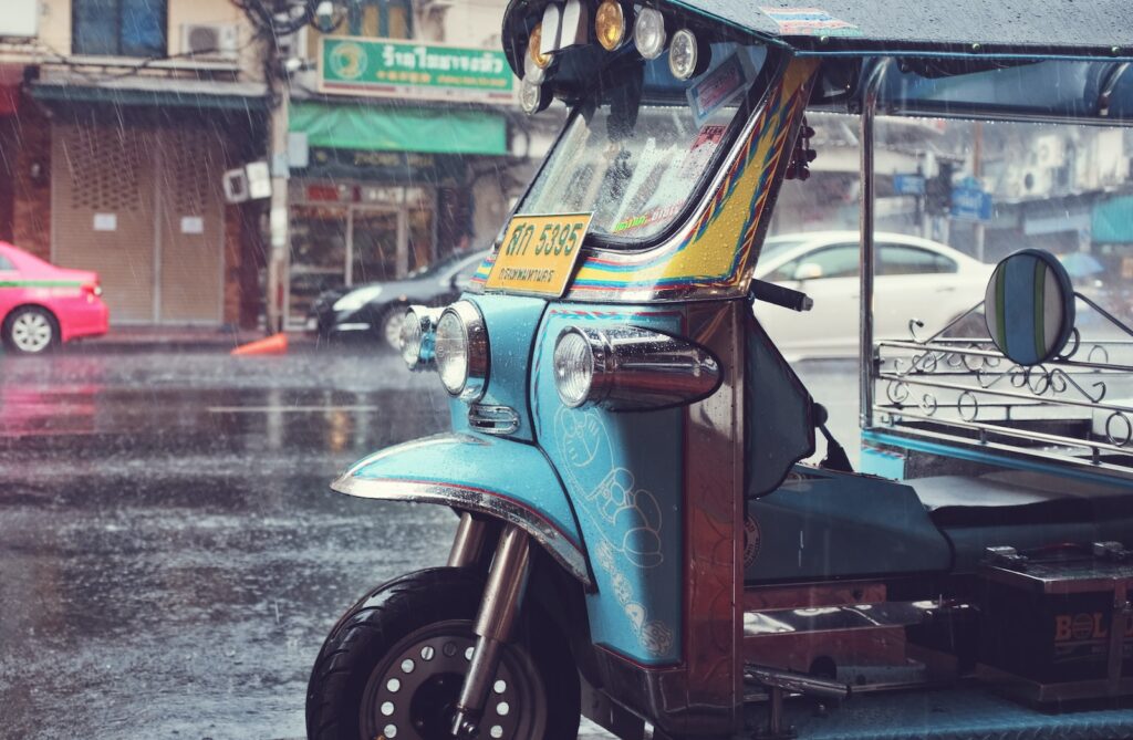 auto rickshaw outside store at raining season